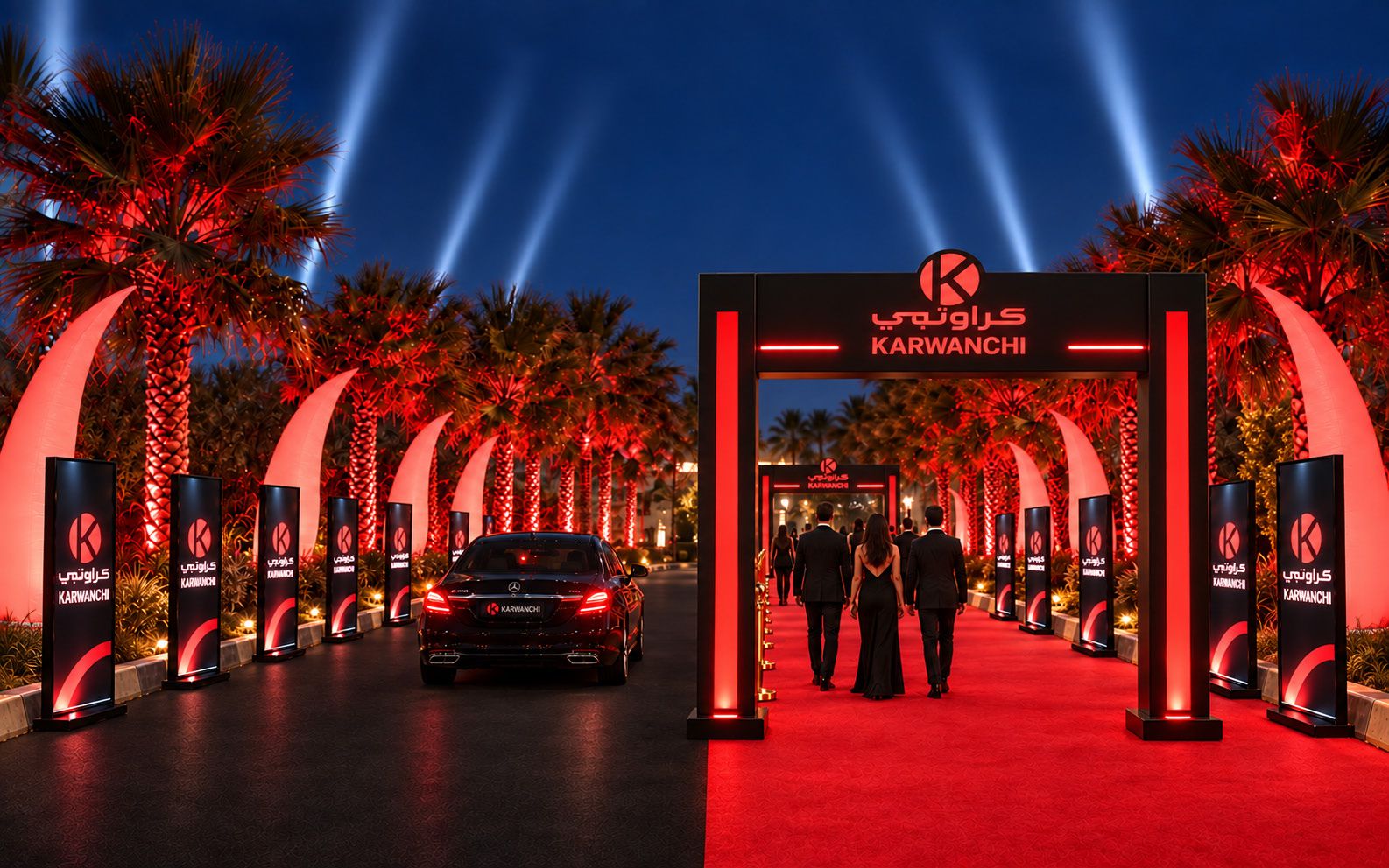 Branded gateway, red-carpet walkway and black vehicle lane lined with screens and lit inflatables