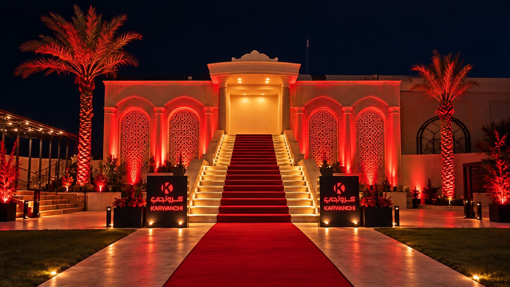 Galaxy Hall entrance lit red, with a red-carpet staircase and two Karwanchi signs