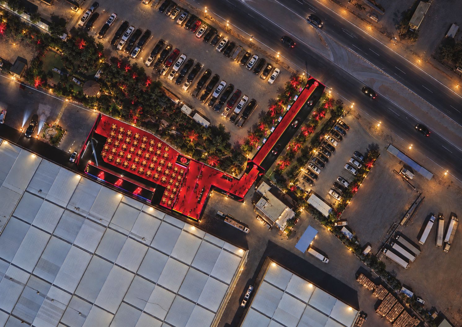 Aerial site plan: red-carpet avenue, corridor and ceremony area beside the warehouses